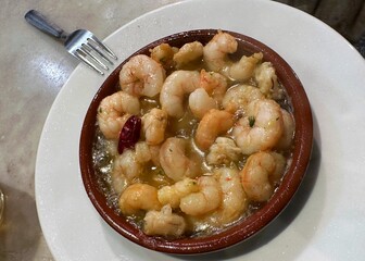 Sizzling shrimp scampi tapa served in a Spanish restaurant in Madrid