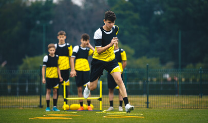Soccer Academy For Teenagers. Youth Football Player in Strength and Agility Training. Young Boys in...