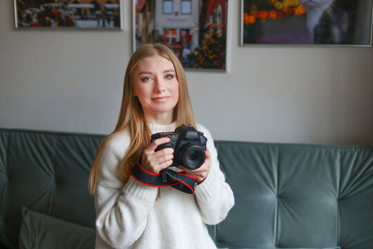 girl with a camera at home ready to take pictures of children