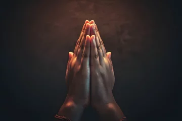 Fotobehang Praying hands with faith in religion and belief in God on dark background. Power of hope or love and devotion. Namaste or Namaskar hands gesture. Prayer position. © john