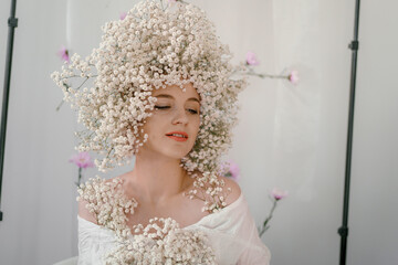 Portrait of sensual blond woman with flowers. Beautiful girl with flowers in her hair. Summer...