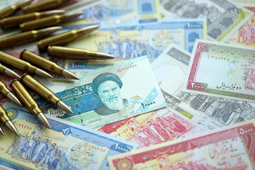 Many bullets and iranian rials money bills close up. Concept of terrorism funding or financial operations to support war in Iran - obrazy, fototapety, plakaty