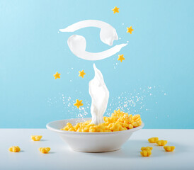 Zodiac sign Cancer of milk levitates over breakfast plate of cornflakes and milk on blue...
