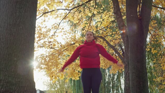 Sartorial Sweat: Admire the Exquisite Beauty of a Girl Exercising with Style in the Heart of Autumn, Exhibiting a Perfect Fusion of Fashion and Active Living. High quality 4k footage
