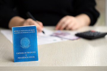 Brazilian work card and social security blue book lies on accountant or boss table close up