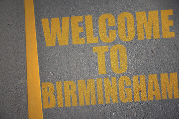 asphalt road with text welcome to Birmingham near yellow line.