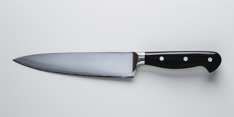 A knife with a black handle is placed on a clean white surface. Perfect for kitchen or cooking-related designs