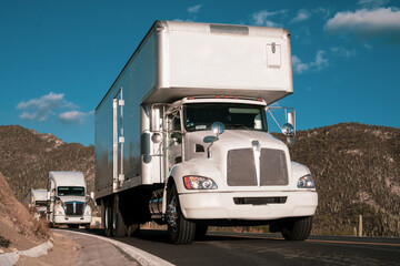 Trailers on the highway at dusk hauling commercial cargo.