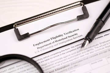 I-9 Employment Eligibility Verification blank form on A4 tablet lies on office table with pen and...