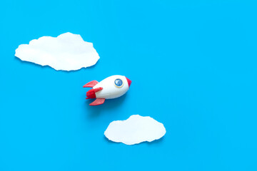 space rocket flying on the sky with clouds , strart up business concept