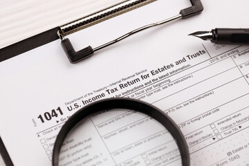 IRS Form 1041 US Income tax return for estates and trusts, blank on A4 tablet lies on office table...