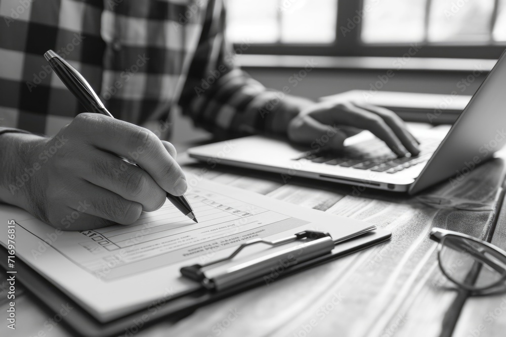 Aufkleber a person is sitting at a table with a laptop and a pen. this image can be used to depict someone wor