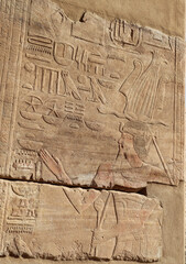 Ancient egyptian hieroglyphics carved on walls of Satet temple on Elephantine island in Aswan, Egypt