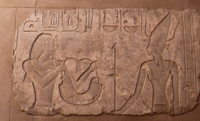Ancient egyptian hieroglyphics carved on walls of Satet temple on Elephantine island in Aswan, Egypt