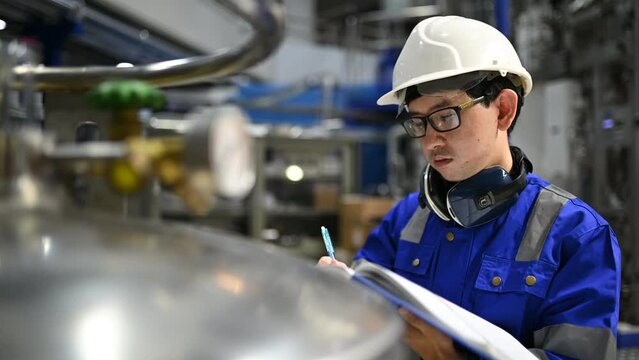 Asian engineer working at Operating hall,Thailand people wear helmet  work,He worked with diligence and patience,she checked the valve regulator at the hydrogen tank.