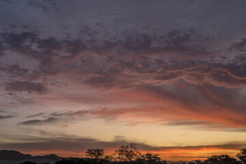 red clouds of scenic sunset on desert at Serisem, Naukluft desert,  Namibia