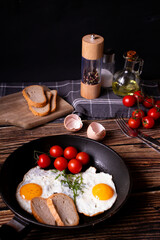 
Fried eggs in a pan. on a wooden background. Breakfast