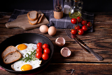 
Fried eggs in a pan. on a wooden background. Breakfast