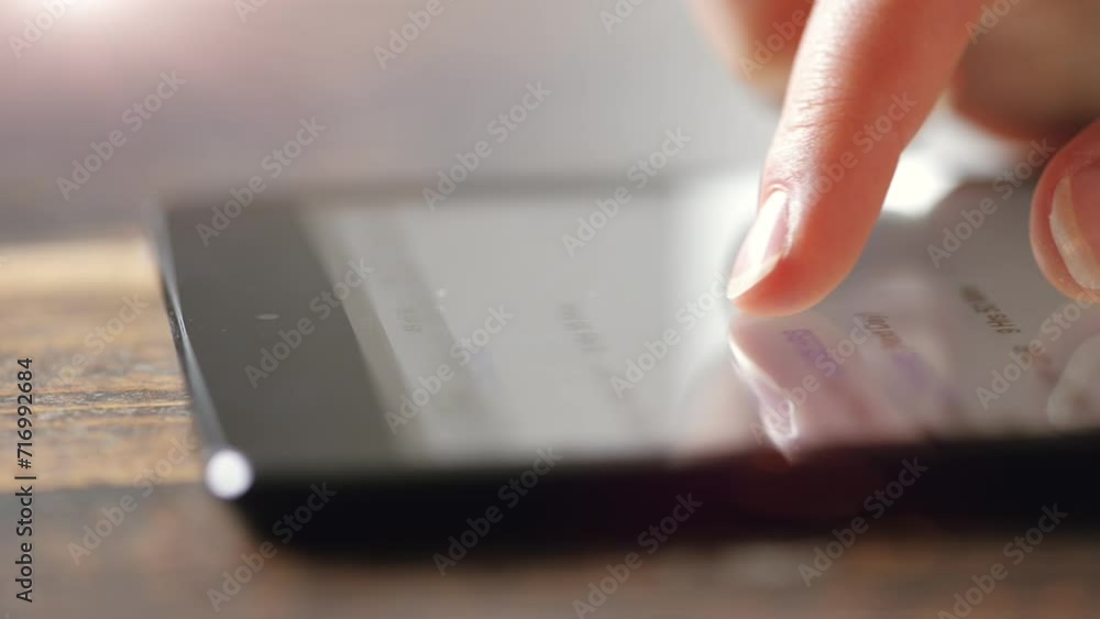 Poster phone, finger scrolling on display for information or research closeup in studio on wooden table. ha