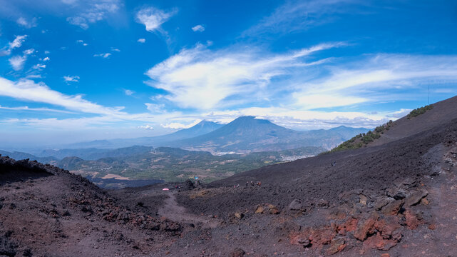 Agua, Fuego, and Acatenango Volcanoes from the Pacaya Volcano with a stunning sky full of clouds in Guatemala
