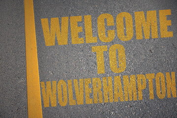 asphalt road with text welcome to Wolverhampton near yellow line.