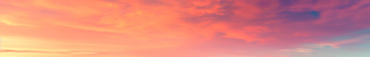 Vibrant extra wide panoramic sky. Fantasy banner sky. Rich colors. Daytime sunset beauty. Fiery glowing heavenly sky with gradient colors. Red, pink, orange, blue, yellow. Red fiery sunrise