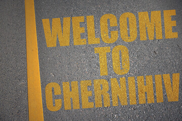 asphalt road with text welcome to Chernihiv near yellow line.