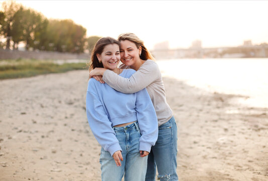 Mother and teen daughter on sandy beach