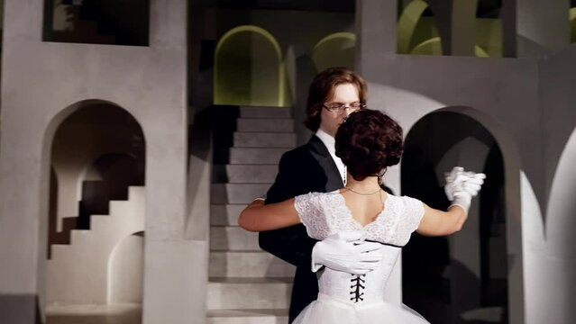 fabulous ball in royal palace, beautiful woman and handsome man dancing waltz, slow motion
