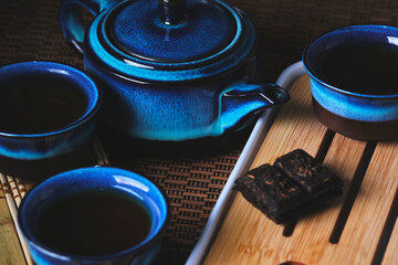 Tableware for tea ceremony . Blue tea set pottery on bamboo napkin.