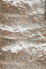 snow on a stone relief