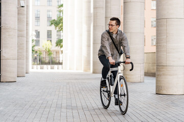 Modern urban commuter on a stylish bicycle in a cityscape, embodying eco-friendly transportation.