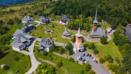 Aerial photography of Barsana monastery located in Maramures County, Romania. Photography was taken from a drone at a higher altitude with camera tilted downwards for a top view shot of the monastery.