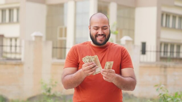 Bald indian Man Feeling Happy while Counting Money, Indian Rupees