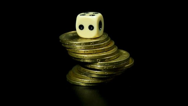 Gold coins dice gamble business on black background