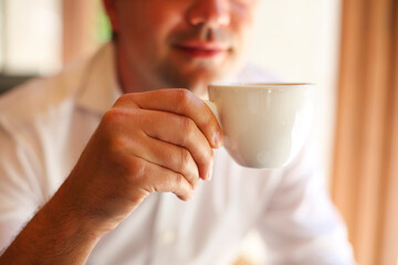 Young businessman with cup of coffee