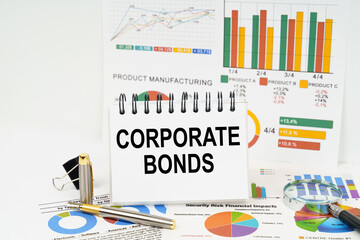 On the table are reports with graphs and a notepad with the inscription - Corporate Bonds
