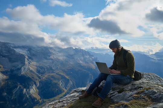 man with laptop on mountain