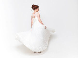 Fototapeta na wymiar Young pretty caucasian bride in wedding dress