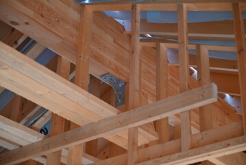 Fototapeta na wymiar Wooden frame structure house building on a new development framing of under construction