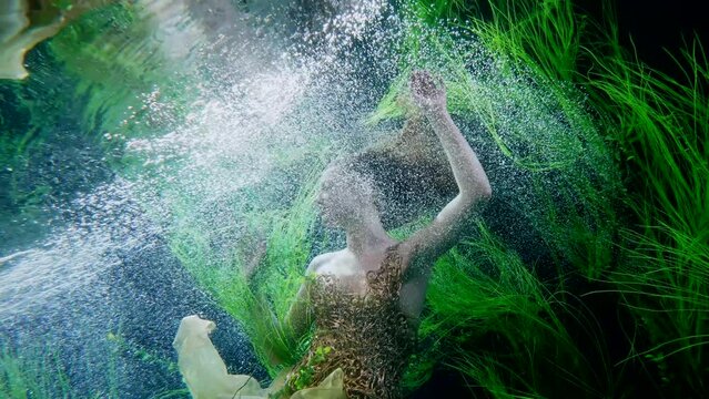 fabulous underwater shot with beautiful mermaid princess swimming in depth, slow motion