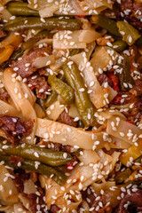 Delicious Asian dish udon with hot peppers, green beans, spices and herbs