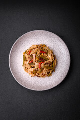 Delicious Asian dish udon with hot peppers, green beans, spices and herbs