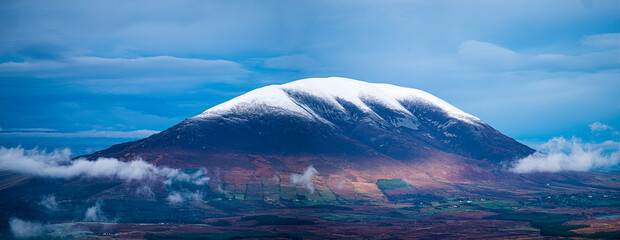 Snow on Nephin mountain dramatic sky low clouds