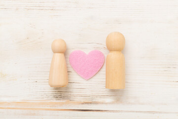 Wooden couple in love on wooden background, top view. Creative valentine's day composition