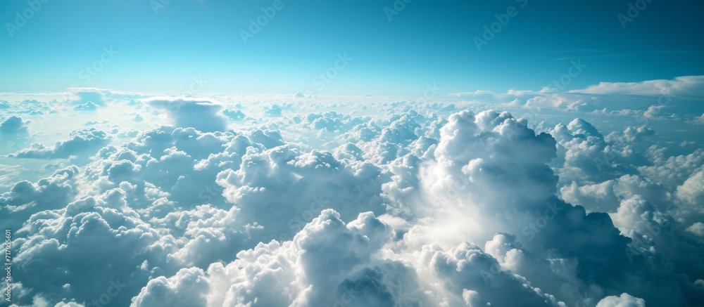 Poster observe the clouds and sky from the airplane during the journey.