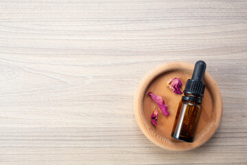 Alternative medicine. Endobiogenics, new look at medicine, bottle of essential oil on wooden background. Copy space
