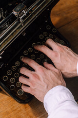 A writer typing on a vintage typewriter - 717059874