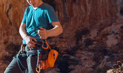Man is engaged in the rock climbing and mountaineering.