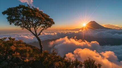 Sun rising behind volcan agua that is covered in clouds except the peak